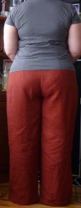 Me, from the back, wearing orange trousers and a grey tee.