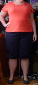 Me wearing knee length navy pants (knickerbockers) and a bright coral t-shirt.